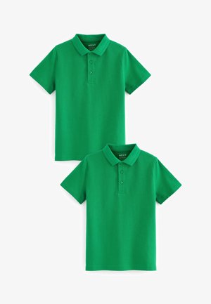 Chemises polo en coton vert, à manches courtes, avec deux boutons au col, texture lisse, présentées en position empilée.