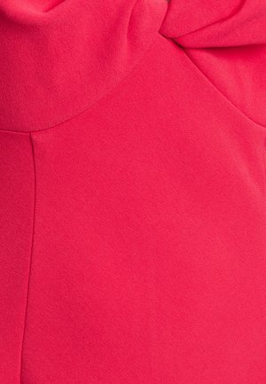 Pink fabric with a smooth, slightly textured finish. Features a gathered top section, creating a soft drape. No visible patterns or hardware.