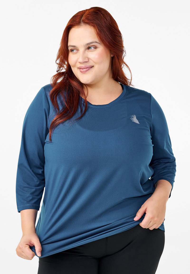 Blue long-sleeve shirt made of smooth fabric with a round neckline, featuring a small logo detail on the chest and relaxed fit.