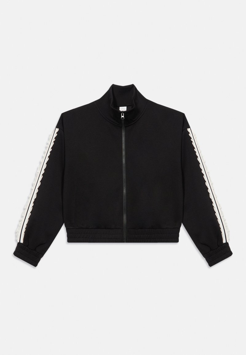Sort cropped zip-jakke med høj krave, der har hvide stribede detaljer og tekstureret udsmykning langs ærmerne. Blødt stof, afslappet pasform.