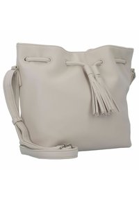 Helle beige Leder-Bucket-Bag mit strukturierter Oberfläche, dekorativer Quaste und verstellbarem Riemen. Verfügt über silberfarbene Beschläge.