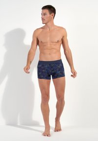 Navy blue boxer briefs with floral pattern in green and black. Elastic waistband, fitted design, made from stretchable fabric for comfort.