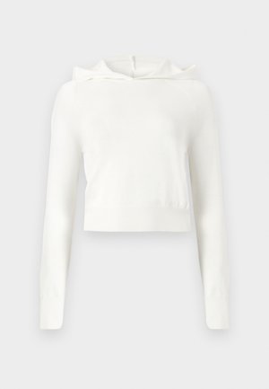 Balta īsa kapuce ar garām piedurknēm un ribotas aproces un apkakles malu, attēlota uz vienkārša fona.