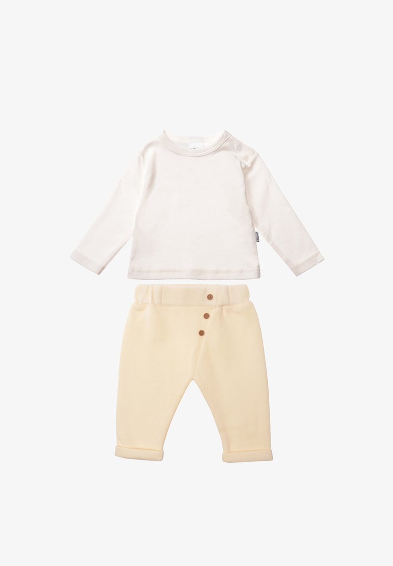 Cream long-sleeve shirt and yellow soft pants with three wooden buttons at the waist and rolled cuffs, made from lightweight fabric.