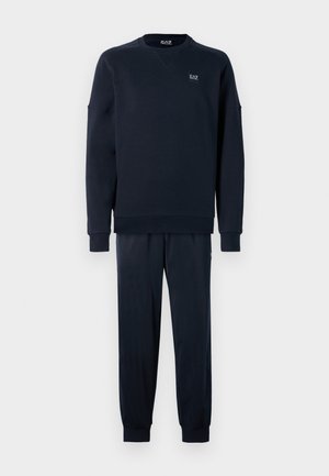 Juego de sudadera y pantalones de chándal de color azul marino; la sudadera tiene un cuello redondo y puños acanalados; los pantalones presentan puños de tobillo elásticos y un corte ajustado.