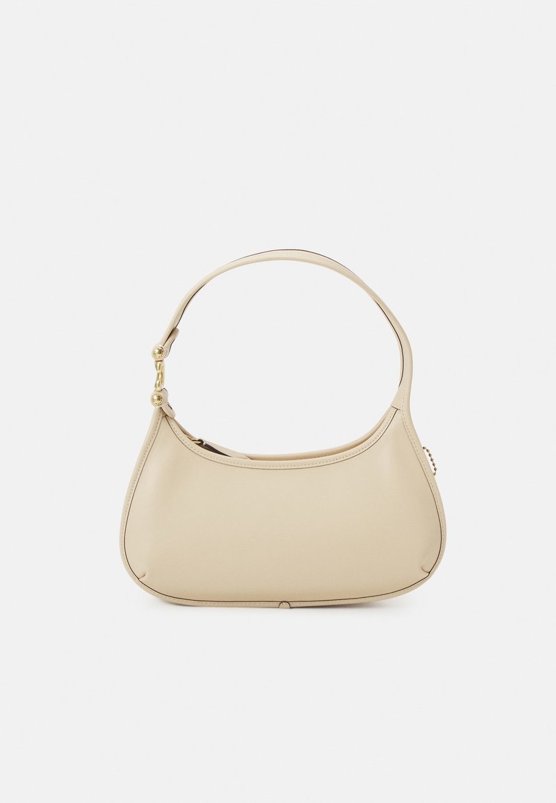 Petit sac à bandoulière en cuir beige avec une seule sangle et des détails en métal doré sur fond blanc.