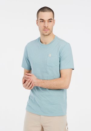 Light blue short-sleeve t-shirt with a crew neckline and a left chest pocket. Made of soft fabric with a subtle texture.