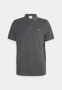 Polo à manches courtes gris en coton. Il présente un col classique, une patte à deux boutons et un petit emblème sur le côté gauche de la poitrine.