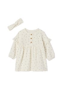 Cremfarbendes Kleid mit schwarzen Punkten, Rüschensäumen und Holzknöpfen. Enthält ein passendes Kopfband mit einem verknoteten Design.