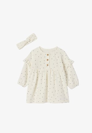 Cremfarbendes Kleid mit schwarzen Punkten, Rüschensäumen und Holzknöpfen. Enthält ein passendes Kopfband mit einem verknoteten Design.
