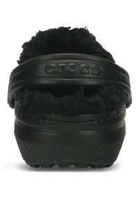 Crocs noirs avec une doublure en peluche douce et duveteuse. Matériau en caoutchouc lisse avec un design ouvert et léger. Semelle extérieure texturée pour une meilleure adhérence.
