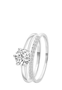 Two interlocking silver rings; one features a large round diamond, the other has a row of small diamonds along its band.