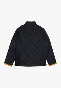 Schwarze gesteppte Jacke mit einem Rautenmuster, ausgestattet mit einem Stehkragen und kontrastierenden gelben Akzenten an den Bündchen. Keine sichtbare Hardware.