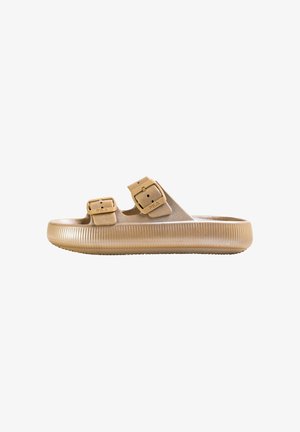 Beige slide sandal made of textured material, featuring two adjustable straps with buckle accents and a ribbed sole.