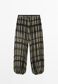 Løse bukser med elastisk talje og manchetter, med lodrette og vandrette ternstriber i brun, sort, creme og lyseblå toner.