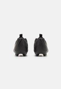 Black football boots with a textured finish, featuring a distinct heel tab and molded studs for traction. Branding visible on the side.
