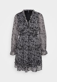 Kjole med sort-hvitt paisley mønster, v-hals, lange gjennomsiktige ermer, volanger, og innsnevret midje. Laget av lett stoff.