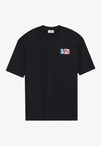 Black cotton t-shirt with short sleeves. Features a small, multicolored graphic patch on the left chest depicting stylized designs.