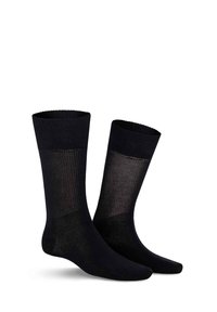 Schwarze Socken mit gerippter Textur und einem glatten, opaken Finish. Mittlere Wadenlänge mit einem kontrastierenden durchsichtigen Einsatz am oberen Teil.