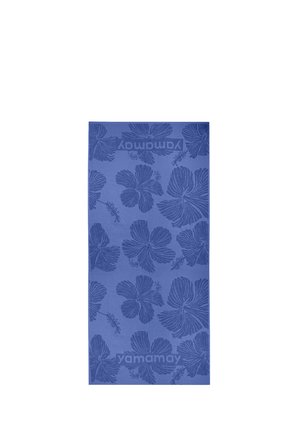 Asciugamano rettangolare blu con grandi motivi di fiori di ibisco e il testo "yamamay" tessuto vicino a entrambe le estremità.