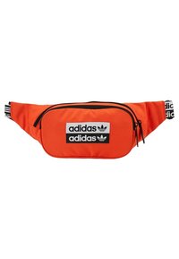 Orange fanny pack made of nylon, featuring two black zippers and three prominent black Adidas logos on the front. Solid color, smooth texture.