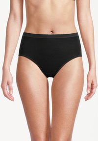 Culotte taille haute noire en tissu doux, présentant une texture lisse et un design épuré sans motifs ni accessoires supplémentaires.