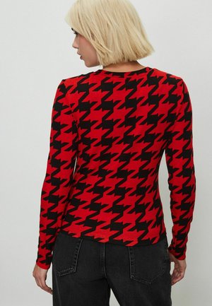 Langärmliges Oberteil mit einem rot-schwarzen Karomuster. Hergestellt aus dehnbarem Stoff, verfügt es über einen runden Halsausschnitt und eine enganliegende Passform.