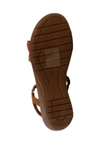 Semelle de sandale brune avec une surface en caoutchouc texturé présentant des rainures et des crêtes pour une meilleure adhérence. Comprend des accents de brides tissées colorées.