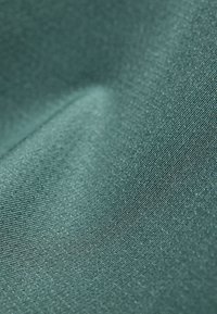 Textile fabric in a deep teal color, featuring a smooth, shiny texture with a subtle, fine ribbed pattern.