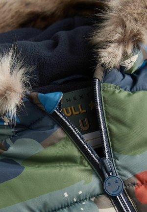 Colorful camouflage puffer jacket featuring a faux fur-lined hood, blue zipper pull, and soft black fleece inner lining.