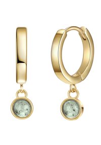 Zelta gredzenu auskari ar gludu apdari un karājo šu apaļu akmeni, kas izceļas ar pienaini zaļu nokrāsu un tumšiem ieslēgumiem.