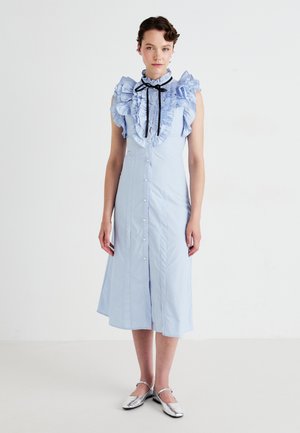 Light blue ruffled dress with a high collar, button-down front, and short sleeves. Features a black ribbon accent and a flowing silhouette.