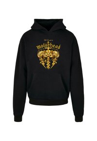 Felpa nera con cappuccio caratterizzata da un design frontale con grafiche dorate, inclusi teschi e fulmini, e una tasca a marsupio frontale.