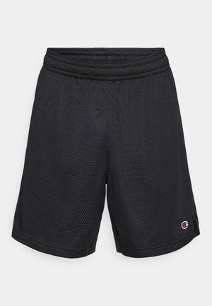 Mustad võrgust sportluspüksid elastse vöökohaga, külgmiste lõhikutega ja väikese logoga alumisel säärel, mida iseloomustab kerge ja hingav disain.