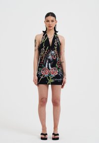 Black halter dress featuring colorful graphic print of a roaring lion, roses, and chain patterns; short length and fitted shape.