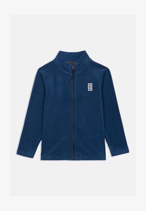 Marineblauwe fleecejack met een hoge kraag, een volledige ritssluiting en raglanmouwen. Bevat een klein wit logo op de borst.
