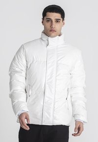Hvid, dunjakke med h�øj krave, quiltet struktur og sidelommer. Lavet af skinnende, glat materiale med lynlås foran.