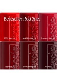 Six Essie nail polish bottles in various red shades labeled Fifth Avenue, Maki Me Happy, Forever Yummy, Bordeaux, Berry Naughty, and Wicked.