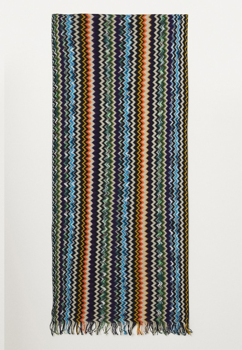 Multicolored woven blanket featuring a zigzag pattern in greens, blues, oranges, and purples, finished with fringed edges.