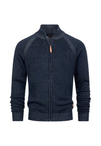 Granatowy sweter zapinany na zamek z wysokim kołnierzem, prążkowaną fakturą i kontrastującym, nakrapianym wzorem. Posiada długie rękawy i małą metkę marki.