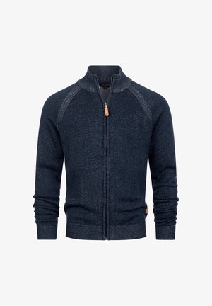 Marineblauwe trui met ritssluiting, hoge kraag, geribbelde structuur en een contrasterend gespikkeld patroon. Heeft lange mouwen en een klein merktekenteken.