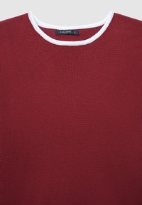 Maglione rosso a maglia con colletto bianco rotondo, caratterizzato da una texture morbida e un design aderente. Etichetta con la scritta "CALLIOPE" taglia S.