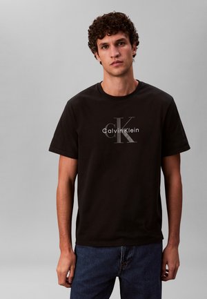 Calvin Klein Jeans HERO MONOLOGO TEE - Nyomott mintás póló - black