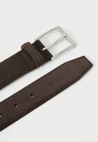 Cinturón de ante marrón con hebilla de metal plateado. El cinturón presenta una textura suave, múltiples agujeros para ajuste y un diseño limpio.