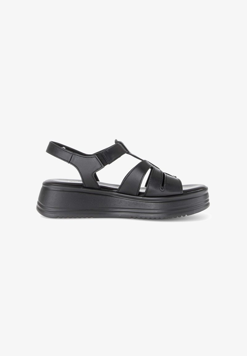 Black leather open-toe sandal with thick sole, adjustable ankle strap, and multiple horizontal straps across the foot.