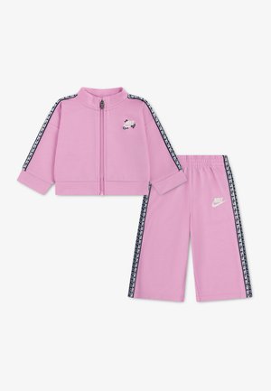 Pink Nike tracksuit set with zip-up jacket and elastic waist pants, featuring black and white side stripes and small Nike logos.