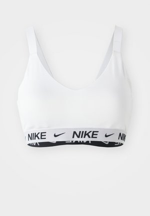 Soutien-gorge de sport blanc avec un décolleté en V profond. Doté d'un bandeau élastique noir et gris à la base. Tissu lisse, bretelles réglables.