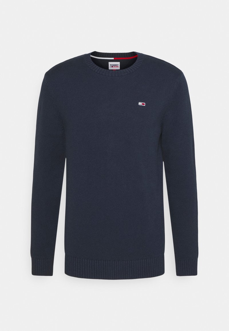 Pull bleu marine à col rond avec poignets et ourlet côtelés, avec un petit logo Tommy Jeans sur la poitrine gauche.