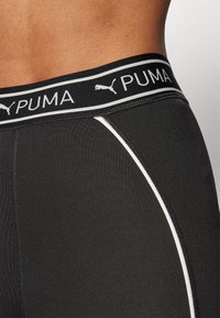 Boxer in nero da uomo con logo PUMA bianco sull'elastico in vita, tessuto liscio con una leggera lucentezza e cuciture bianche curve.