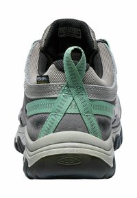 Gray and teal waterproof athletic shoe featuring a textured heel, diagonal cross-straps, and a rugged rubber sole with grooved patterns.